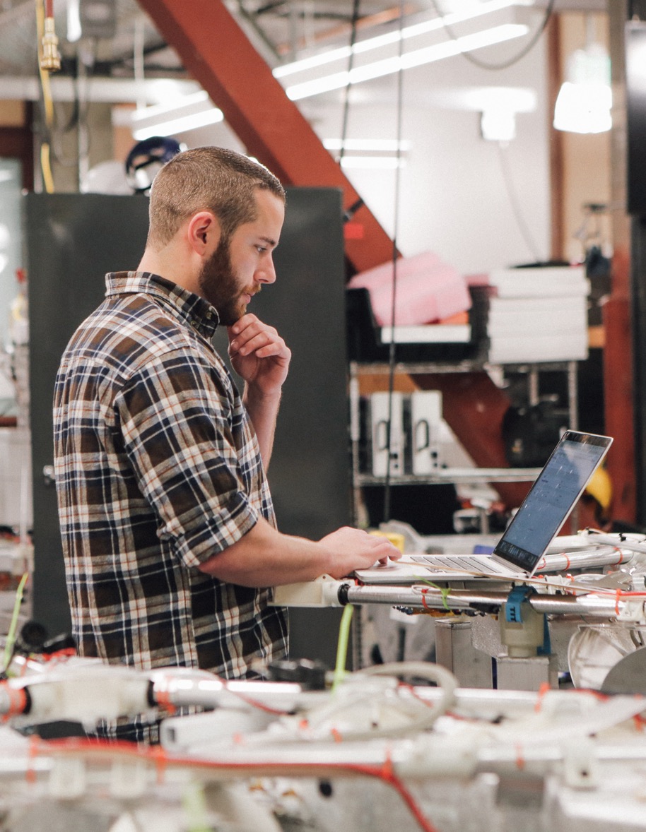 X employee working on computer in a lab.