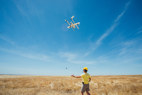 X employee in Australia prepares drone for flight.